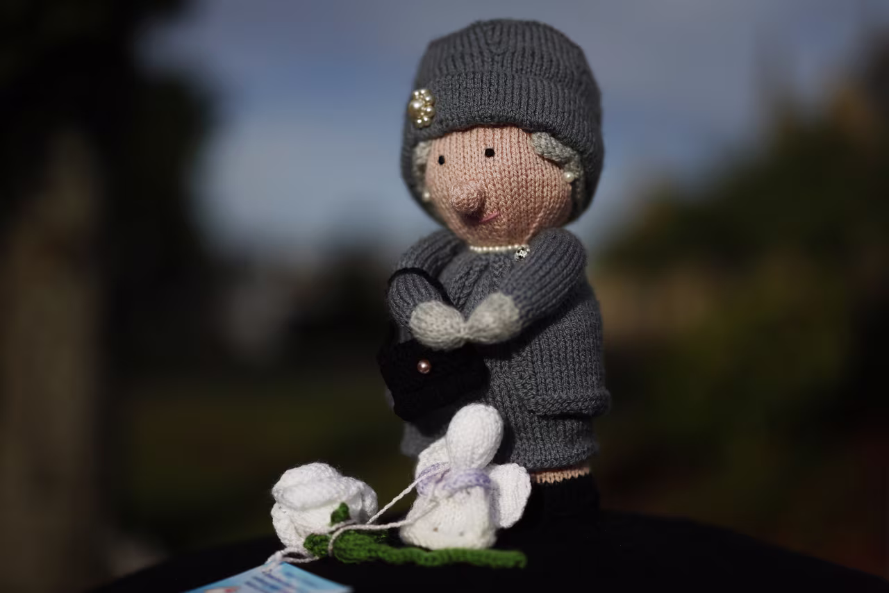 A sewn doll in the likeness of the Queen is seen atop a mailbox in Ballater on Sunday.