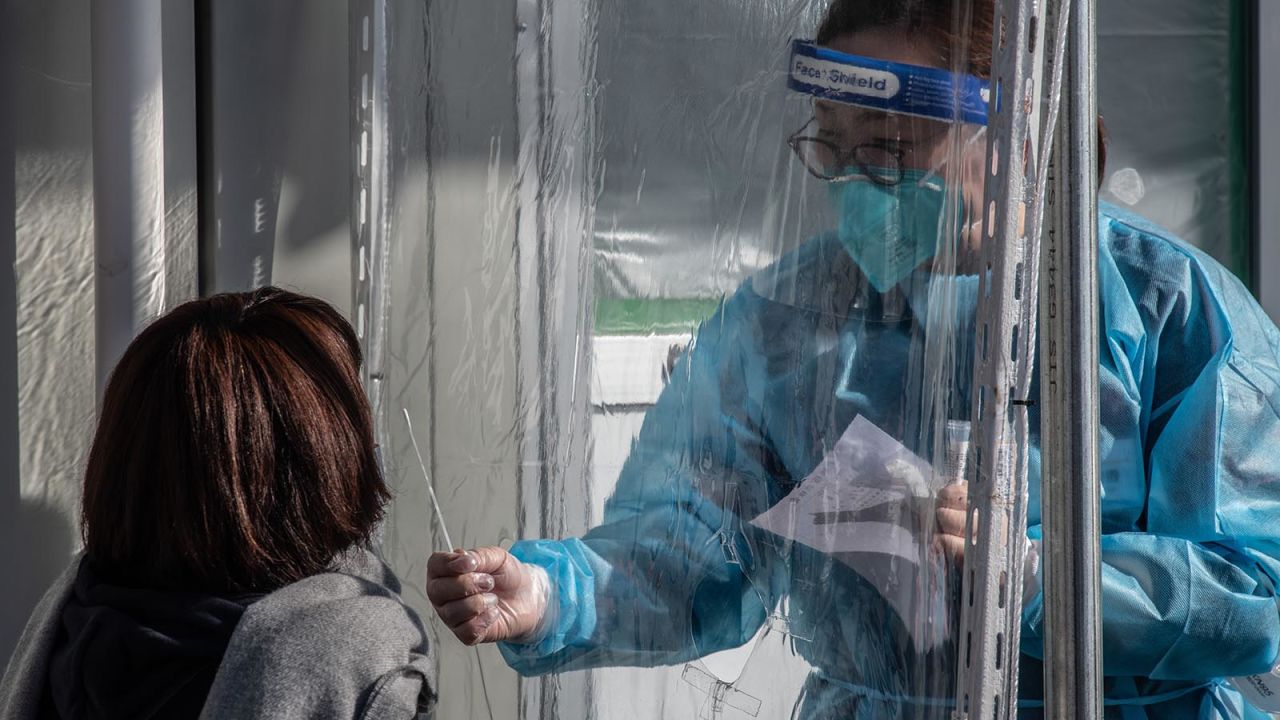 In this December 18, 2020 photo, a nurse collects a nasal swab sample at a Covid-19 coronavirus PCR testing centre at Fujimino Emergency Hospital in Miyoshi-machi, Japan.