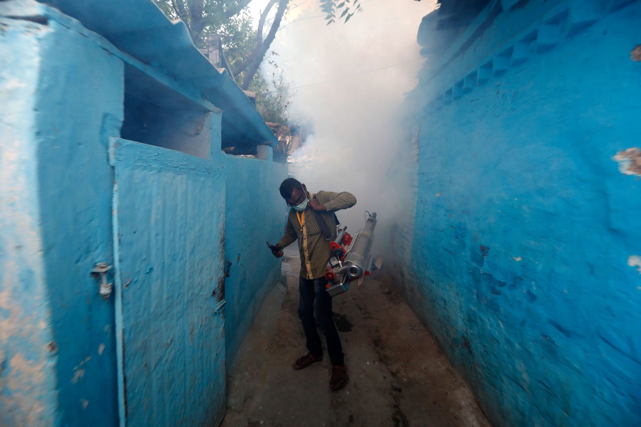 A municipal worker fumigates a residential area in Prayagraj, India, on April 4.