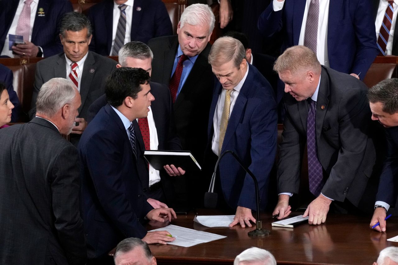 Rep. Jim Jordan stands and talks with Republican House Whip Rep. Tom Emmer as they discuss the tally of the first round of voting, as the House votes for a new speaker, at the Capitol in Washington, DC, on Tuesday.