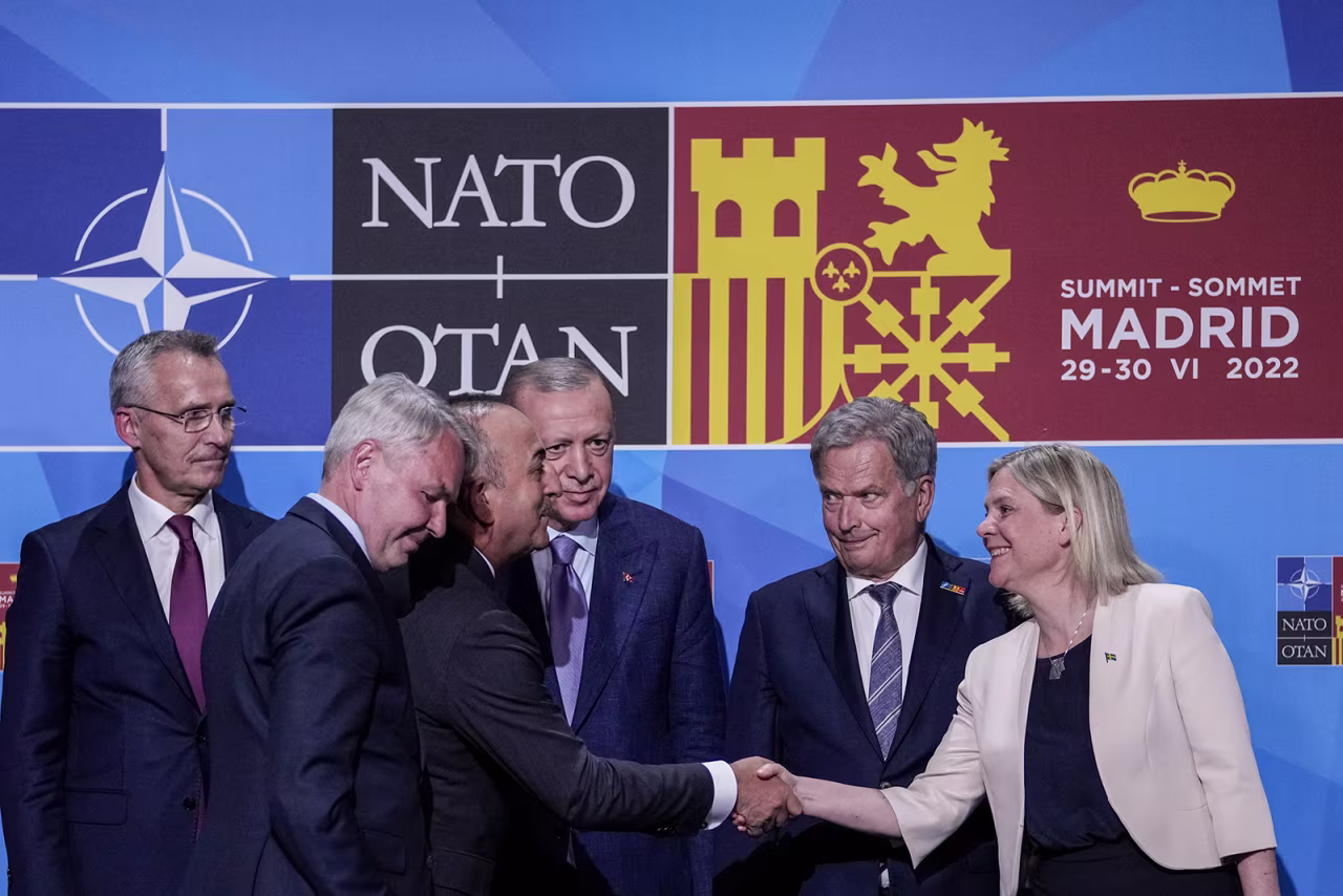Turkish Foreign Minister Mevlut Cavusoglu, thirdf left, shakes hands with Sweden's Prime Minister Magdalena Andersson, right, next to Turkish President Recep Tayyip Erdogan, center, and Finland's President Sauli Niinisto, second right, after signing a memorandum in which Turkey agrees to Finland and Sweden's membership of the defense alliance in Madrid, Spain on June 28. 
