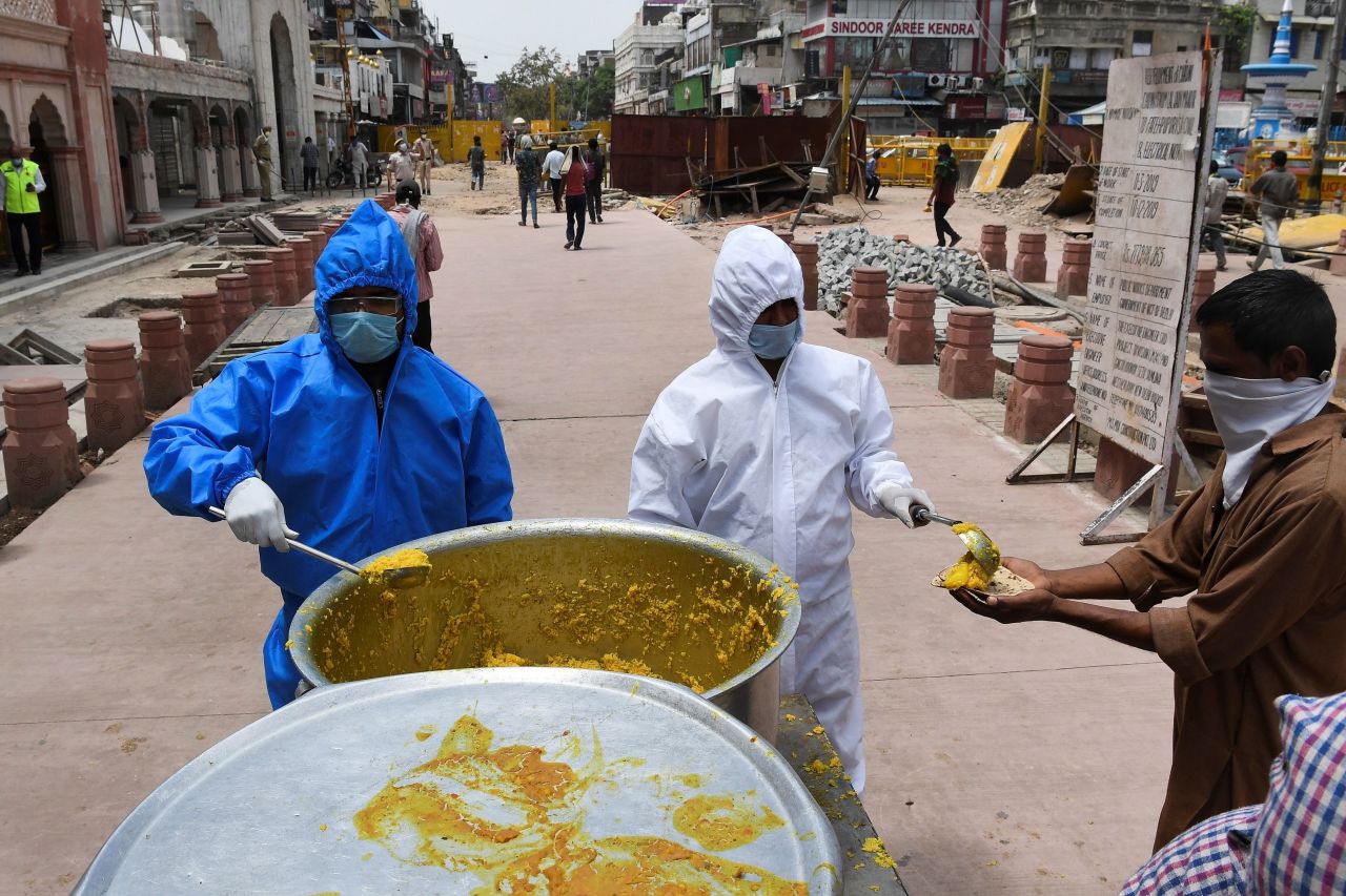 Volunteers from a Sikh temple in New Delhi, India, distribute free food to homeless people during the government-imposed nationwide lockdown measures to prevent the spread of coronavirus on April 15.