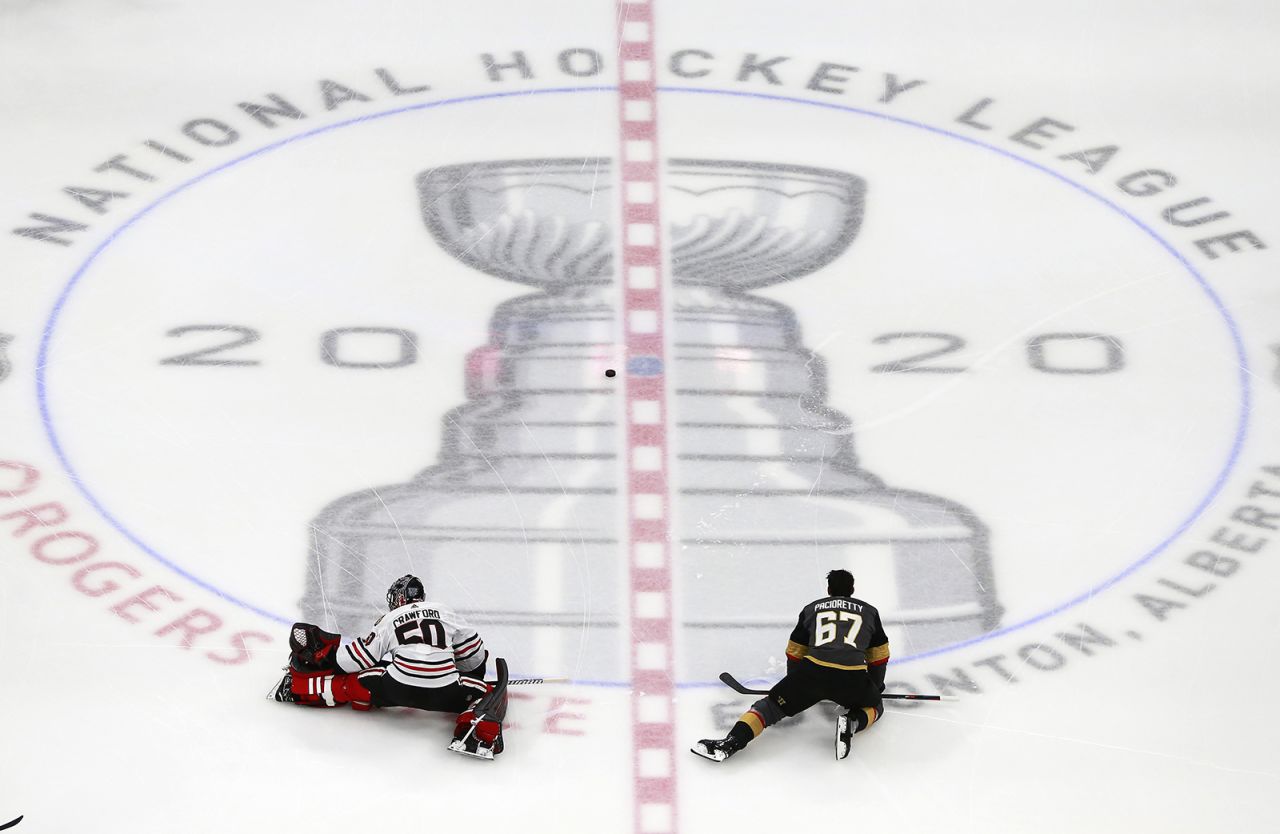 Corey Crawford of the Chicago Blackhawks stretches along with Max Pacioretty of the Vegas Golden Knights before the start of Game One of the Western Conference First Round during the 2020 NHL Stanley Cup Playoffs at Rogers Place on August 11, in Edmonton, Alberta. 