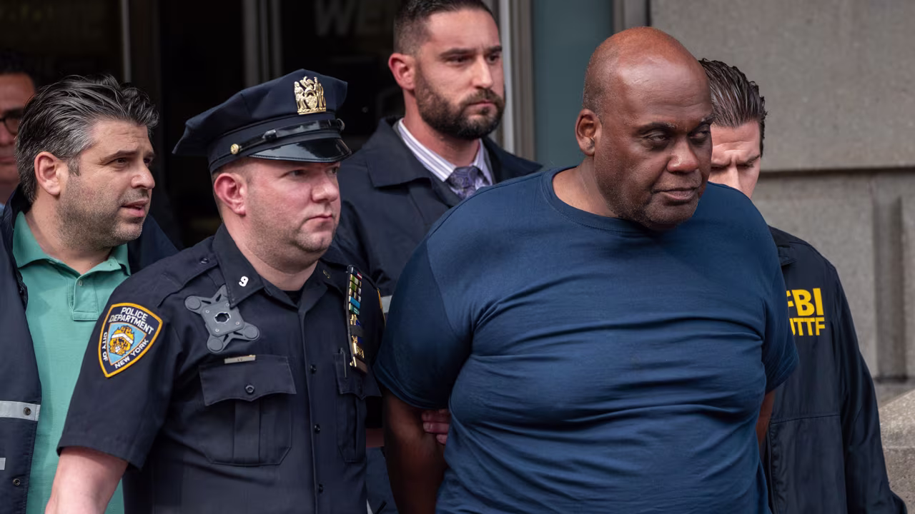 Suspected Brooklyn subway shooter Frank James is escorted out of the 9th Precinct by law enforcement officials after being arrested in New York's East Village neighborhood on Wednesday April 13. 