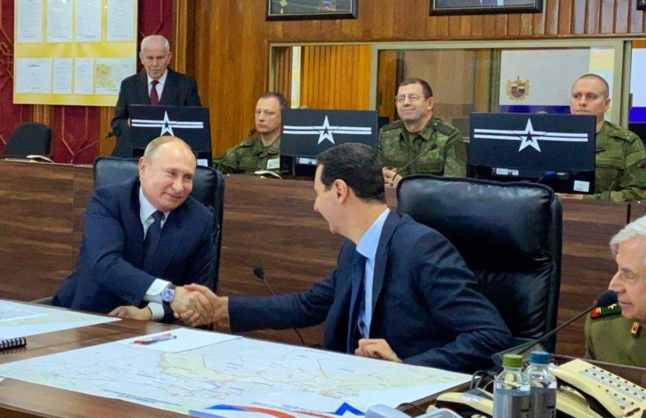 This image released by the Syrian Presidency shows Russian President Vladimir Putin, left, meeting with Syrian President Bashar Assad, center, in Damascus, Syria on Tuesday. Credit: Handout/Syrian Presidency via AP