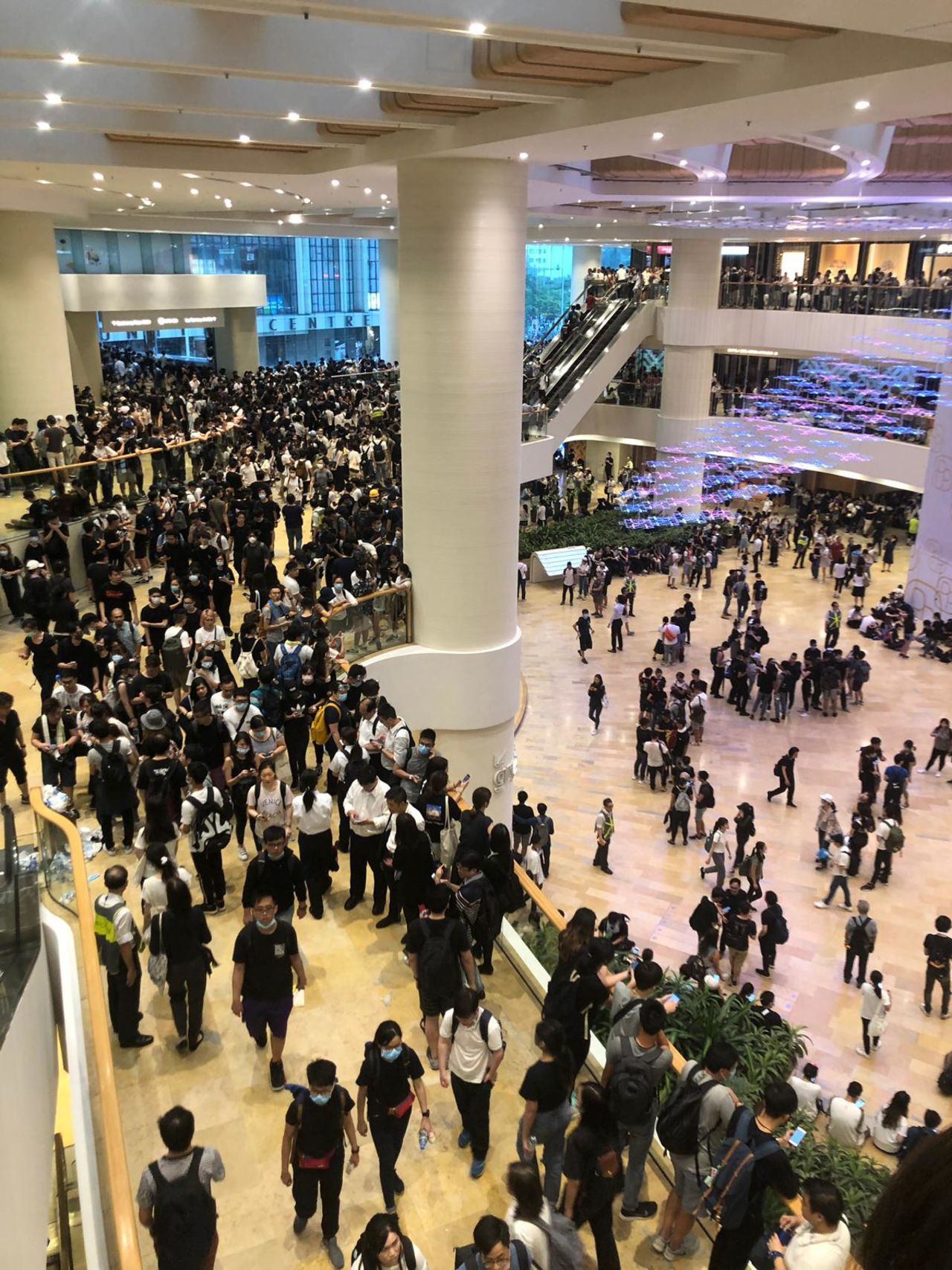 The Pacific Place mall is packed with young protestors, many wearing black shirts and face masks.