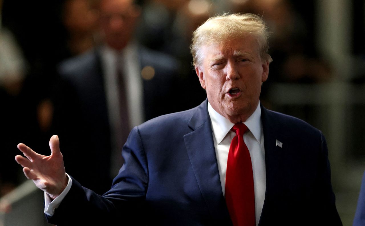 Former President Donald Trump gestures on the day of a court hearing on charges of falsifying business records to cover up a hush money payment to a porn star before the 2016 election, at Manhattan criminal courthouse in New York on Thursday.