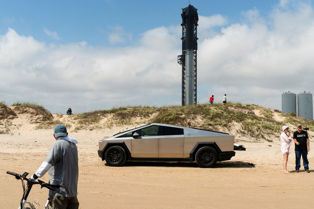 A Tesla Cybertruck is parked on the beach as SpaceX's Starship spacecraft stands on the company's Boca Chica launchpad near Brownsville, Texas, on March 13. 