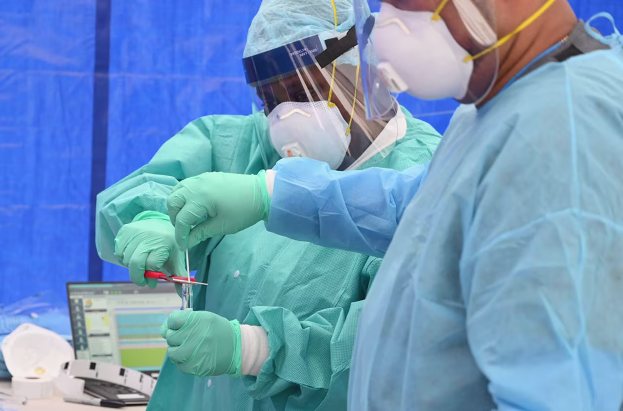 Healthcare workers place a nasal swab from a patient into a tube for testing at the Brightpoint Health and UJA-Federation of New York free pop-up coronavirus testing site on May 8, in the Brooklyn borough of New York City.
