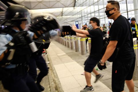 Police scuffle with pro-democracy protestors at Hong Kong International Airport on August 13, 2019.