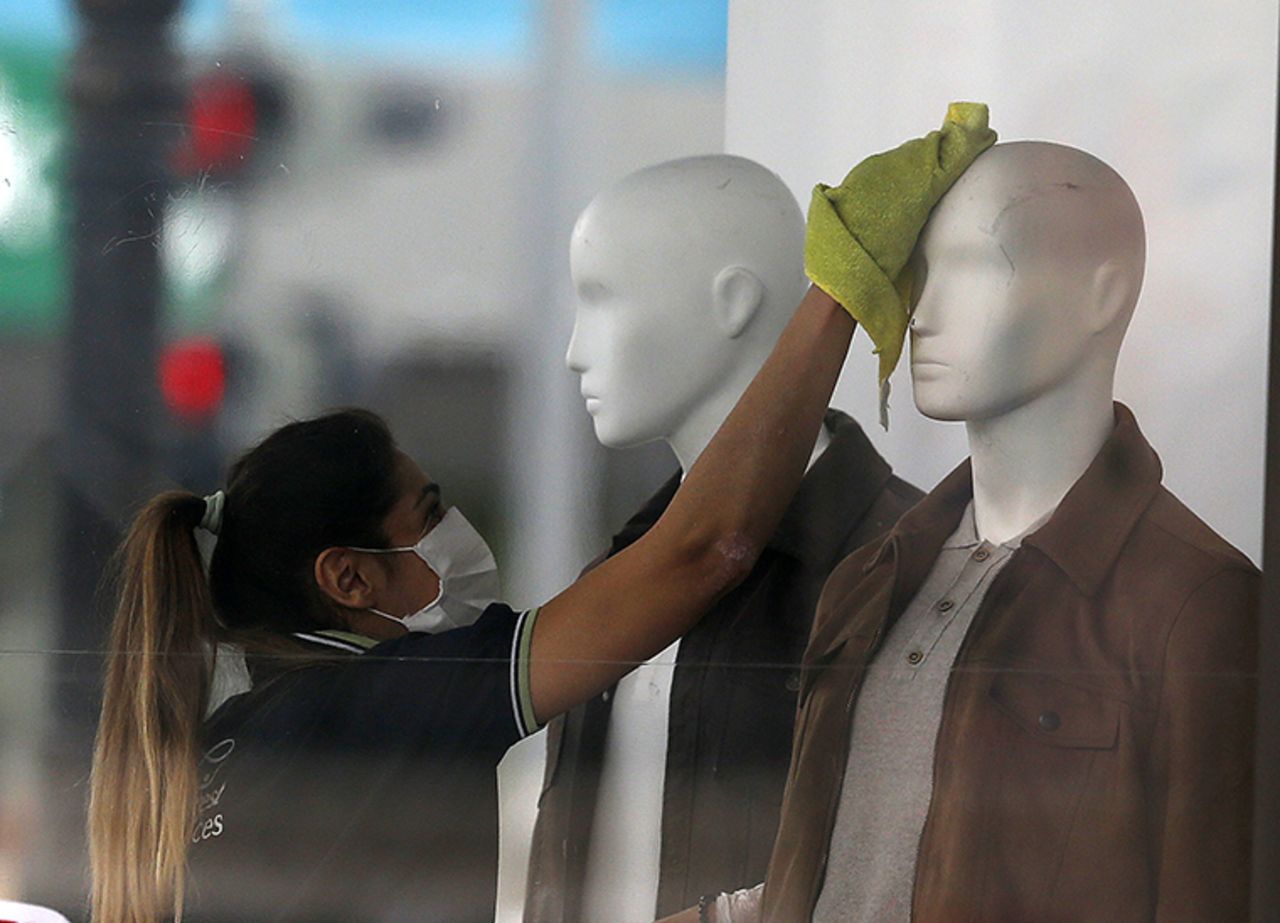 A person wearing a face mask cleans mannequins of a store in Ankara, Turkey on Monday, May 4, after Turkey lifted a 72-hour coronavirus restrictions as of midnight Sunday.