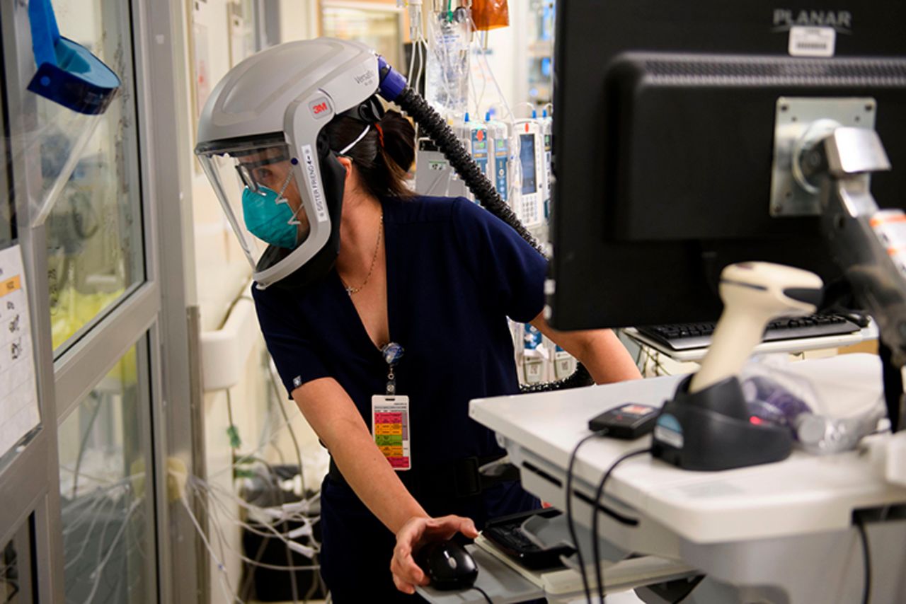 A nurse looks through a door into a patients room in a Covid-19 intensive care unit at Martin Luther King Jr. Community Hospital on January 6, in the Willowbrook neighborhood of Los Angeles, California.