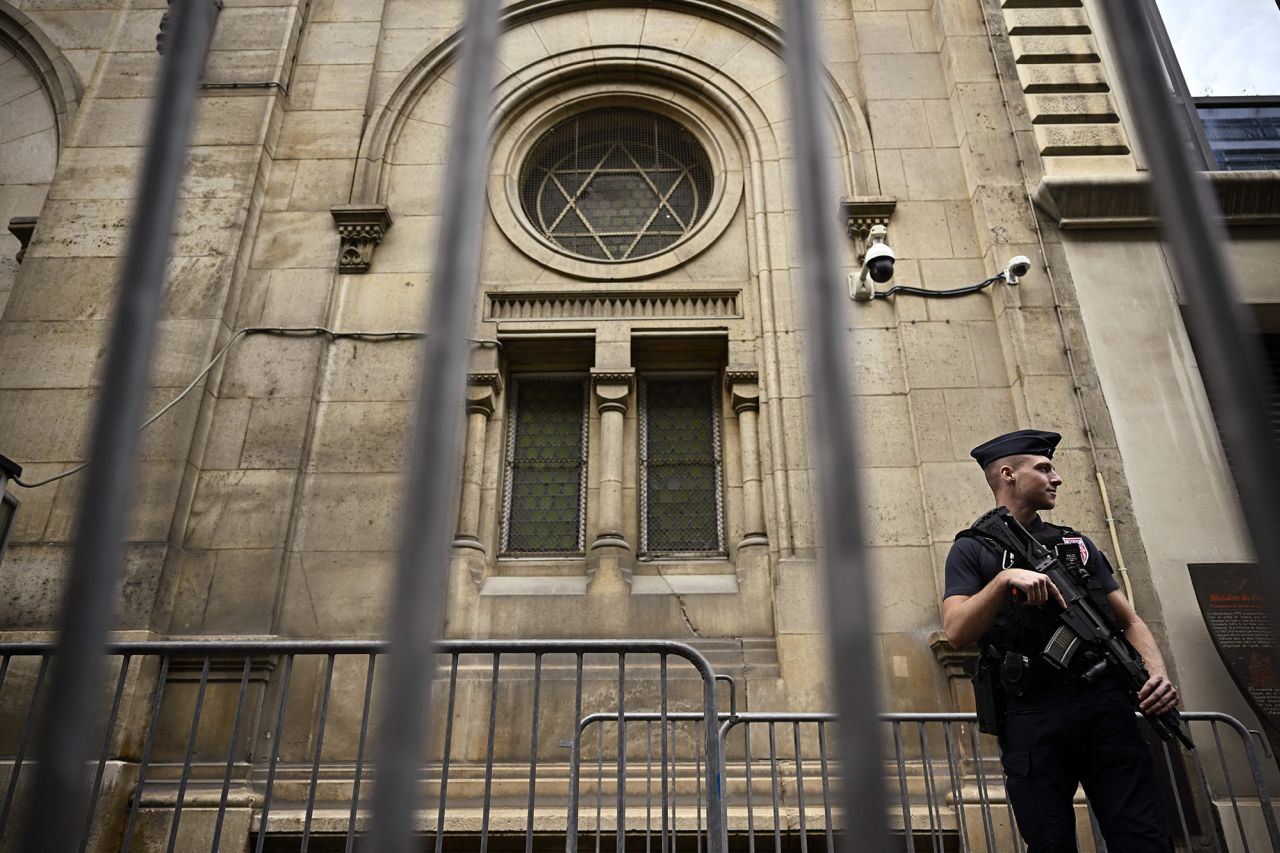 A French riot policeman (CRS) stands guard outside the Paris Synagogue in central Paris, France, on October 9.