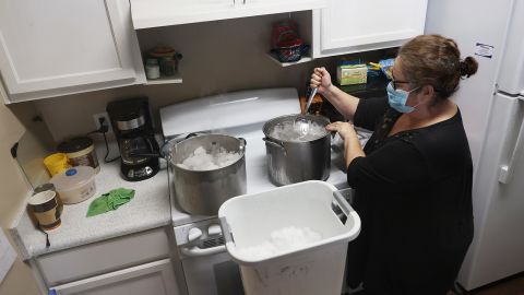 Marie Maybou melts snow on the kitchen stove on February 19 in Austin, Texas. 