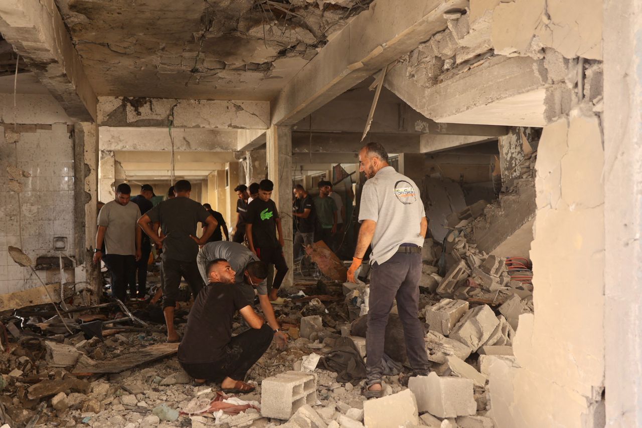 Palestinians inspect the damage at the site of an Israeli strike on a school in Gaza City's Al-Zaytoun neighborhood on September 21. 