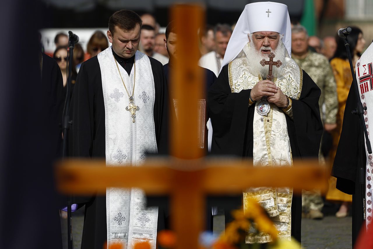 Dignitaries and families attend a ceremony for the fallen soldiers of Ukraine on the Field of Mars in Lviv, Ukraine on Aug. 24.