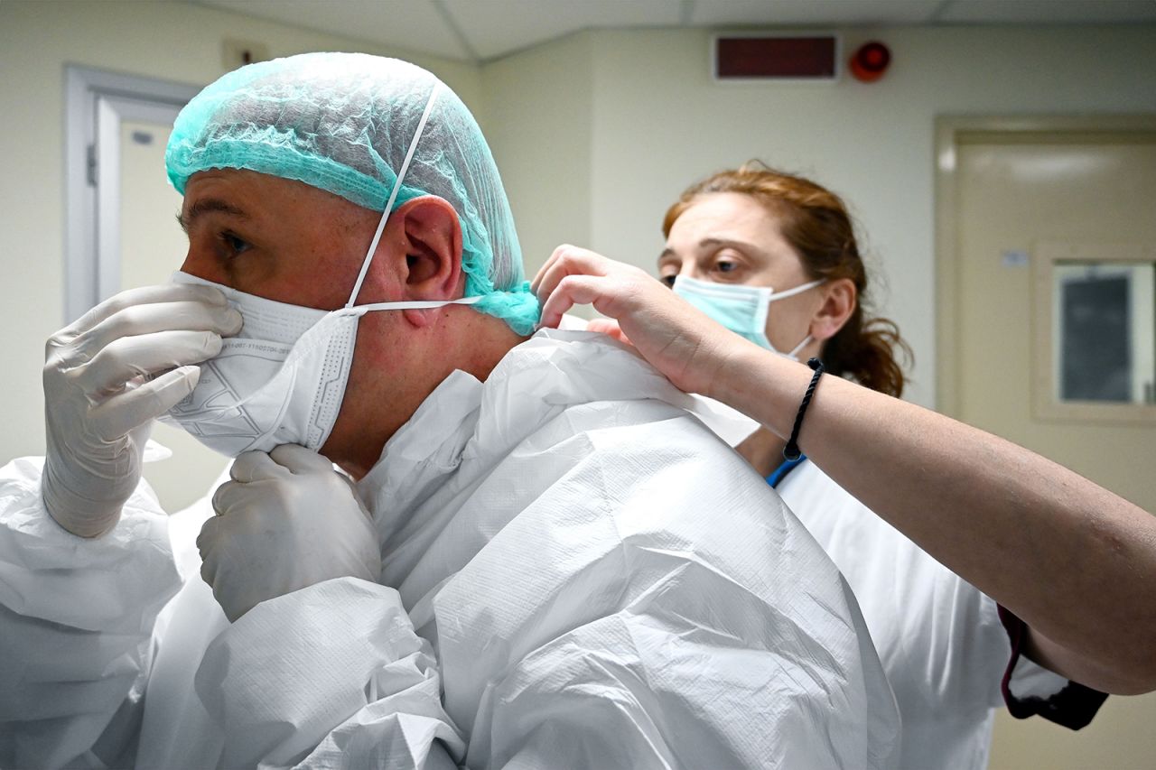 A nurse helps Italian anaesthesiologist Marino De Rosa to put on his mask at the ICU division of the Covid-19 unit at the San Filippo Neri hospital, in Rome, on April 29.