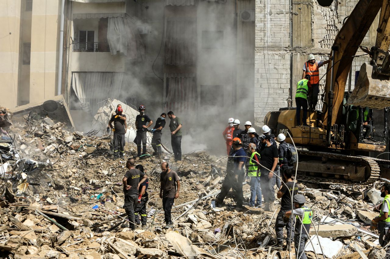 Rescuers sift through the rubble at the scene of an Israeli strike that targeted Beirut's southern suburbs a day earlier, as search and rescue operations continue on September 21. 