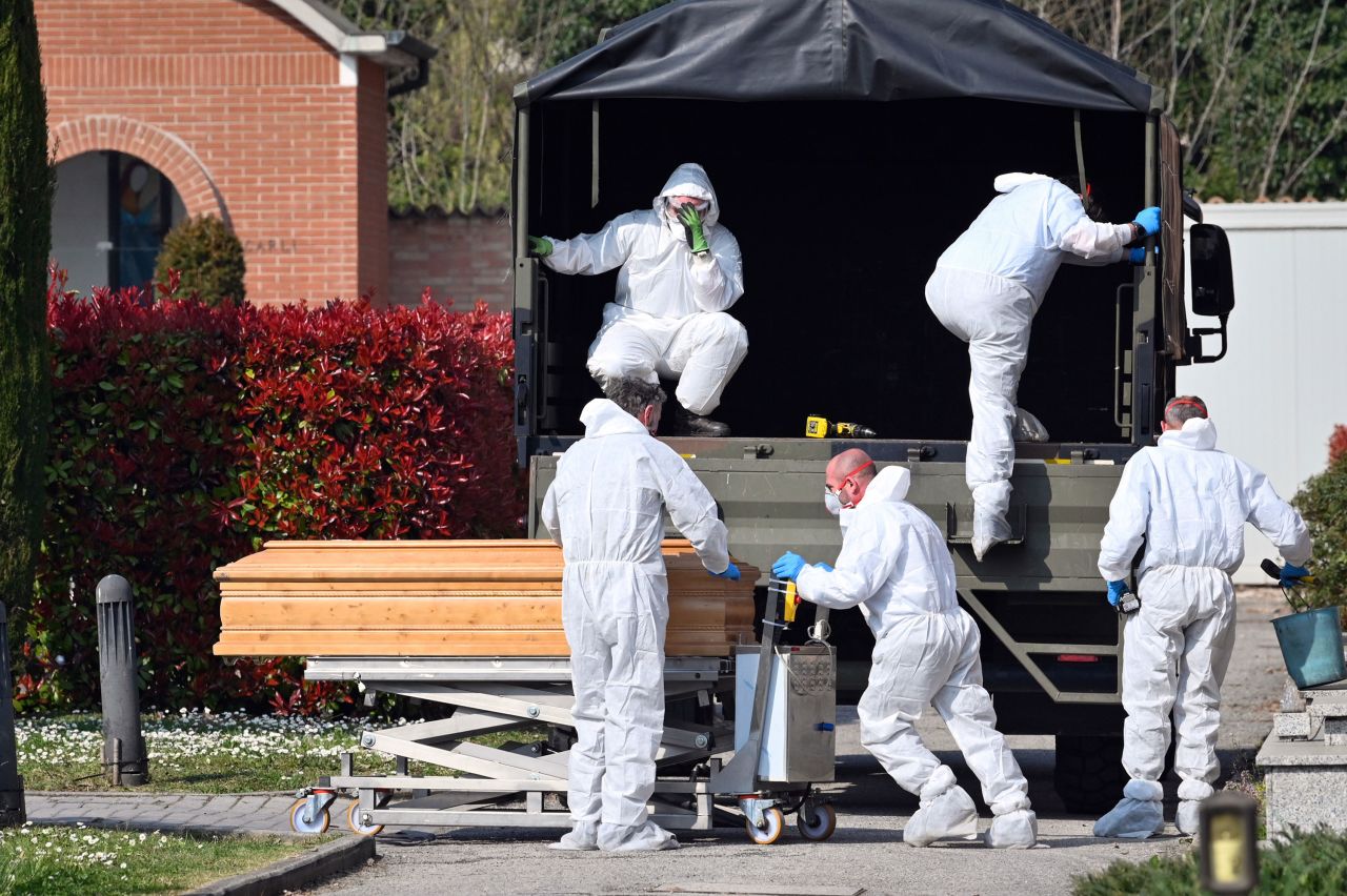 Coffins are downloaded at the Ferrara cemetery, from a military convoy coming from Bergamo, a city at the epicenter of the coronavirus outbreak in northern Italy, March 21.