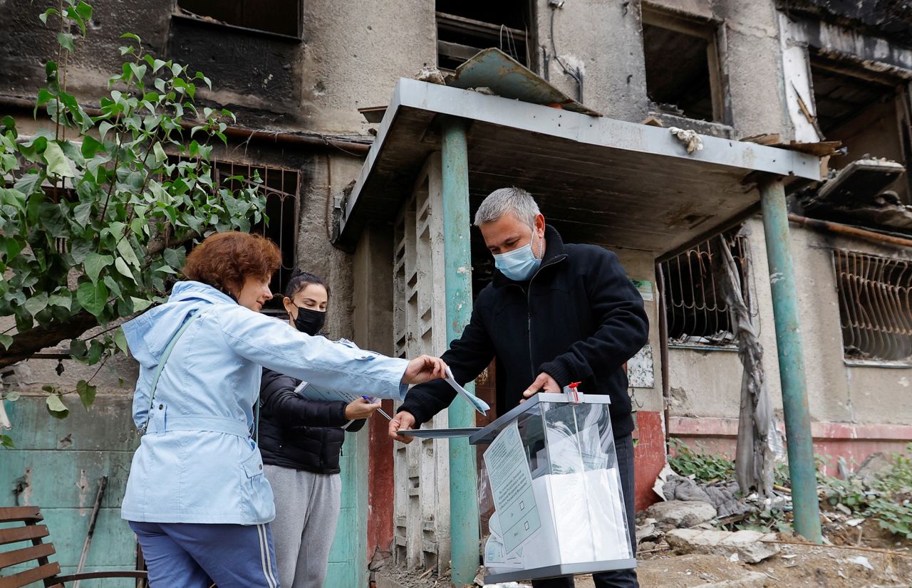 Resident cast a ballot into a mobile ballot box carried by members of an electoral commission on the second day of a referendum on the joining of the self-proclaimed Donetsk People's Republic (DPR) to?Russia, in Mariupol, Ukraine, on September 24.