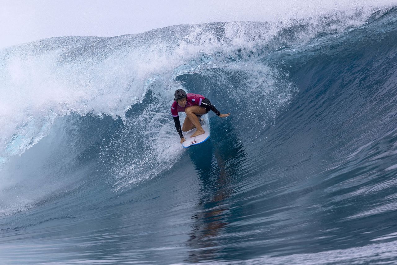 Devay wears a helmet as he rides the wave during the first round on July 27. 