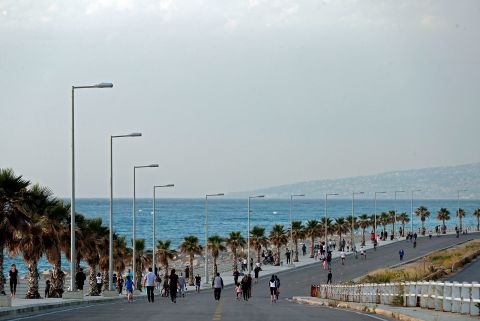 Lebanese people exercise on an empty road by the Dbayeh seaside promenade in Beirut on May 8.