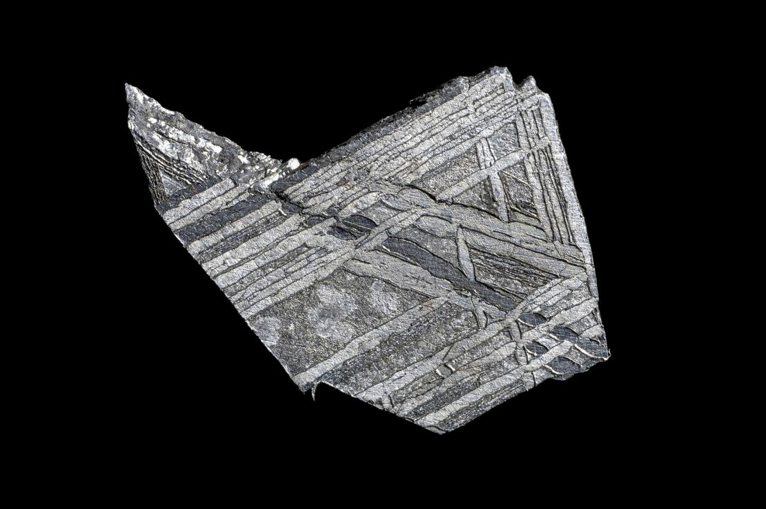 A slice of the Muonionalusta meteorite (not the fragment used in the watch) shows the material's distinctive structure, known as Widmanstätten patterns.