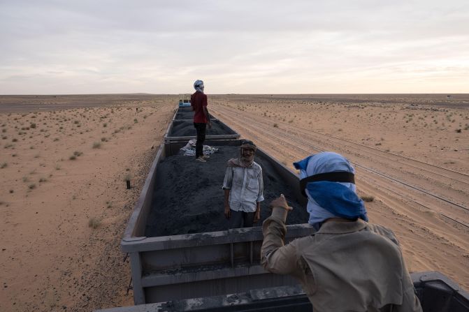 <strong>Train du Desert (Mauritania):</strong> The Train du Desert does have a single passenger car attached to its long procession of iron ore wagons, but adventurous travelers often hitch a free ride on top of the rocks.