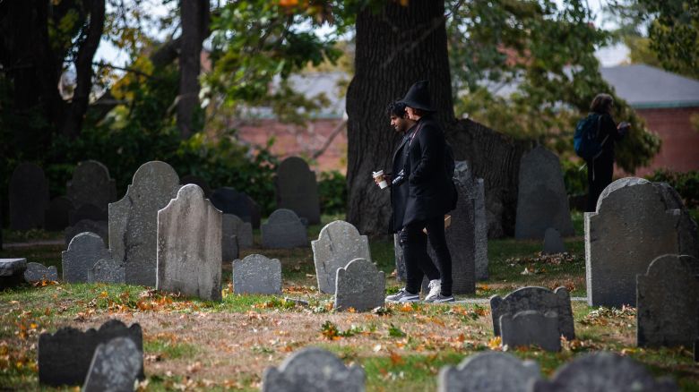 2R19MMT Tourists walk through the Charter Street Cemetery in Salem, MA on Sunday, October 2, 2022.