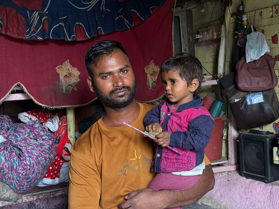 Deepak Kumar holds his daughter Kripa, 1, for whom he has had to take on debt to pay for urgent medical expenses. “If I put her down she starts crying,” he said.