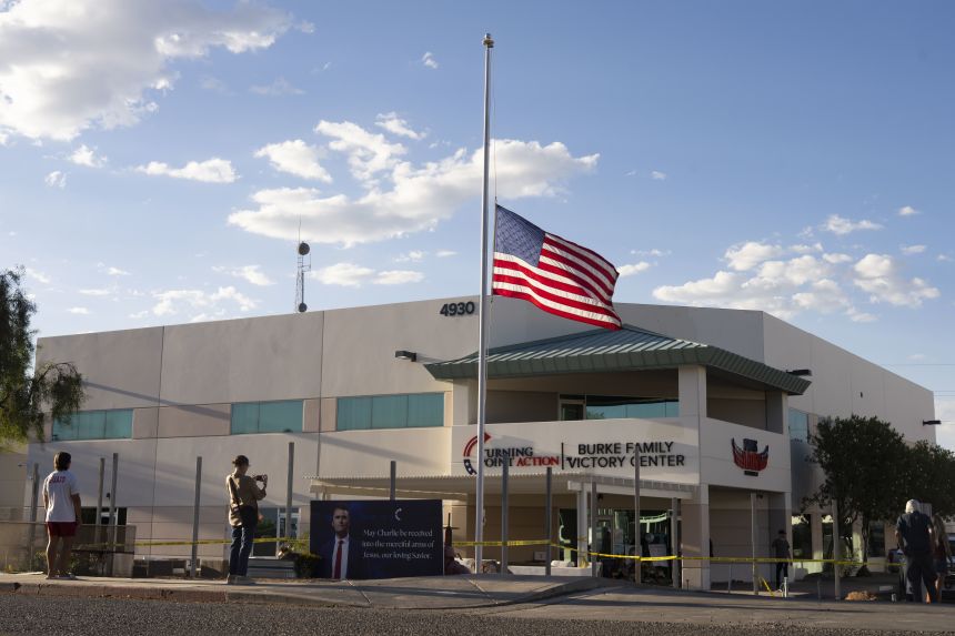 An American flag flies at half-staff as people mourn Turning Point USA Founder Charlie Kirk outside of the Turning Point USA headquarters on Wednesday in Phoenix, Arizona.