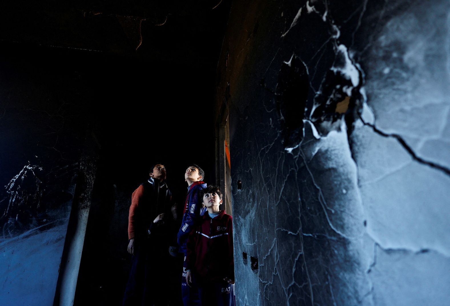 Palestinian children in Khan Younis, Gaza, inspect the site of an Israeli strike that damaged a shelter belonging to Doctors Without Borders on February 21.