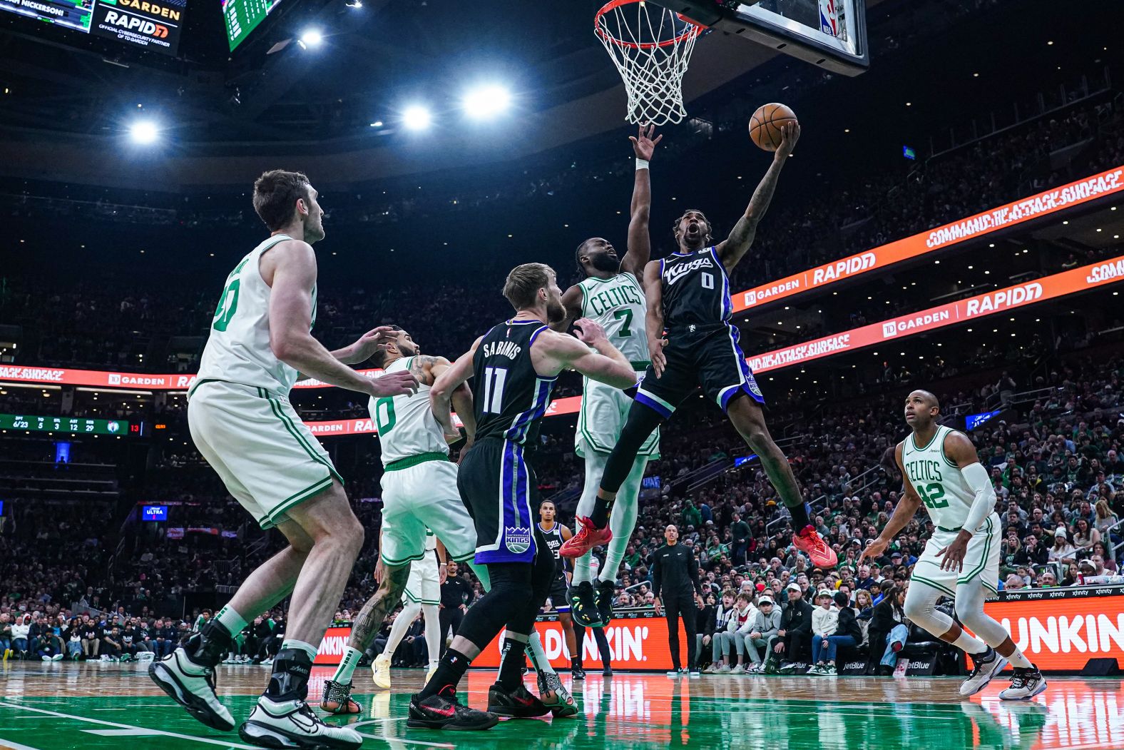 Sacramento Kings guard Malik Monk is defended by Boston Celtics guard Jaylen Brown during an NBA game in Boston on Friday, January 10.