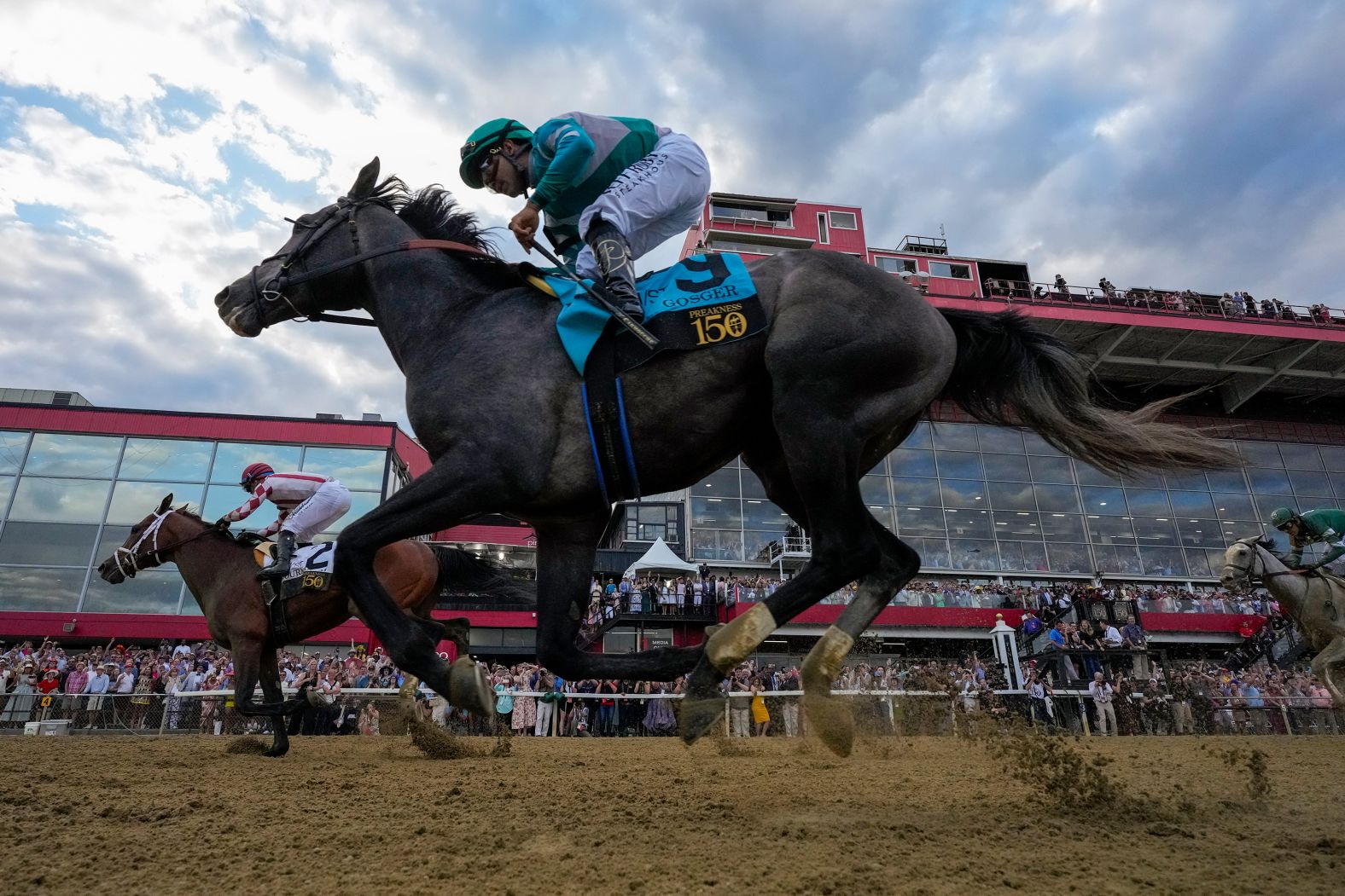 Jockey Umberto Rispoli rides Journalism, left, past Luis Saez and Gosger <a href="https://www.cnn.com/2025/05/17/sport/journalism-wins-150th-preakness-stakes-spt">to win the Preakness Stakes by a half-length</a> on Saturday, May 17.