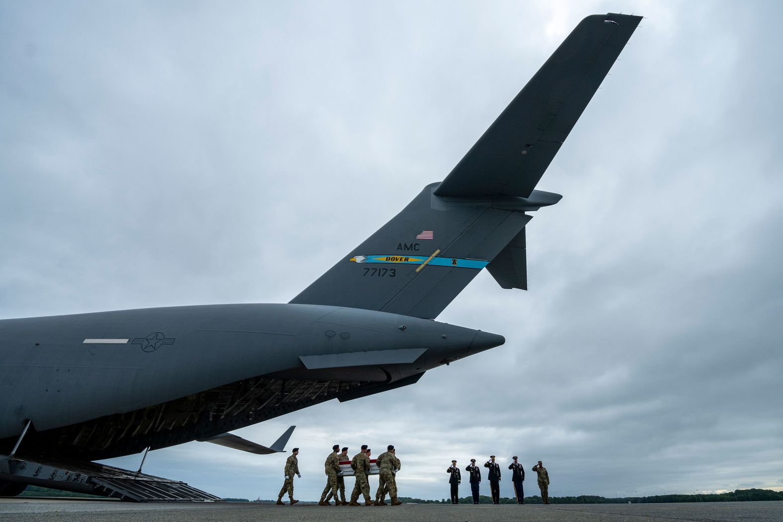 A US Army carry team moves the flag-draped transfer case containing the remains of Spc. Travis J. Pameni at Dover Air Force Base in Delaware on Sunday, August 4. Pameni, 23, of Douglasville, Georgia, died in Baghdad after a noncombat incident in another location, the Army said.