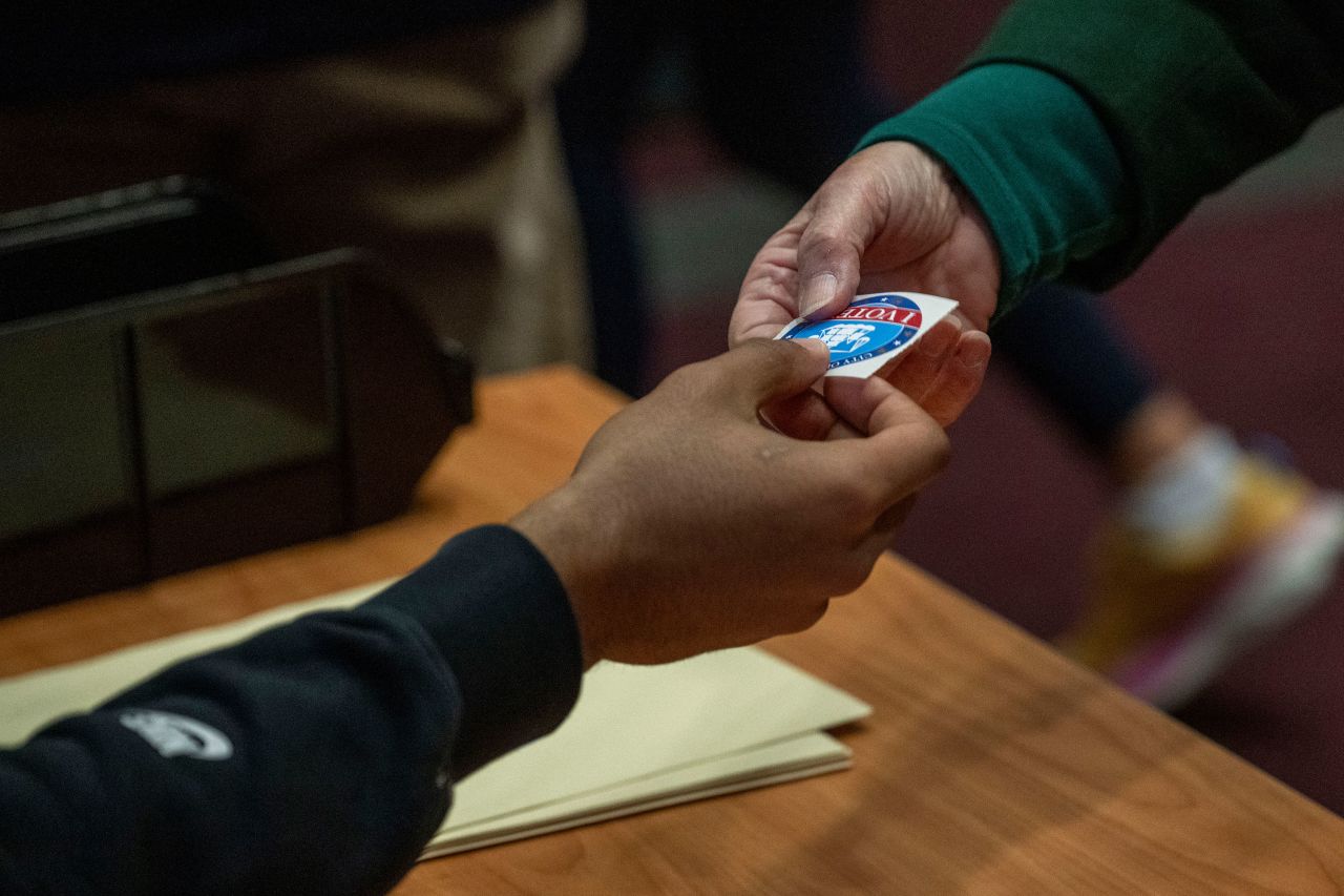 A voter is given a sticker in Alexandria, Virginia.