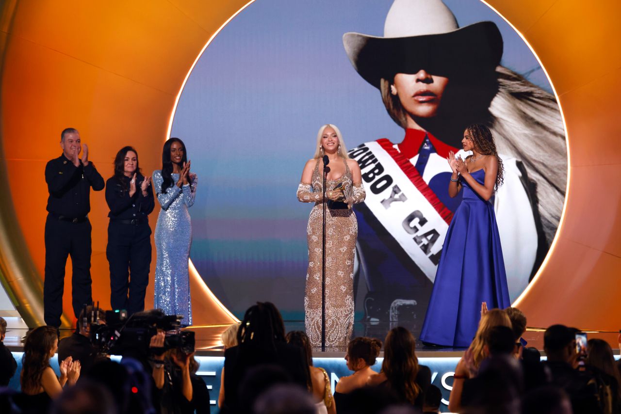 Beyoncé is joined by her daughter, Blue Ivy Carter, as she accepts the album of the year Grammy on Sunday.