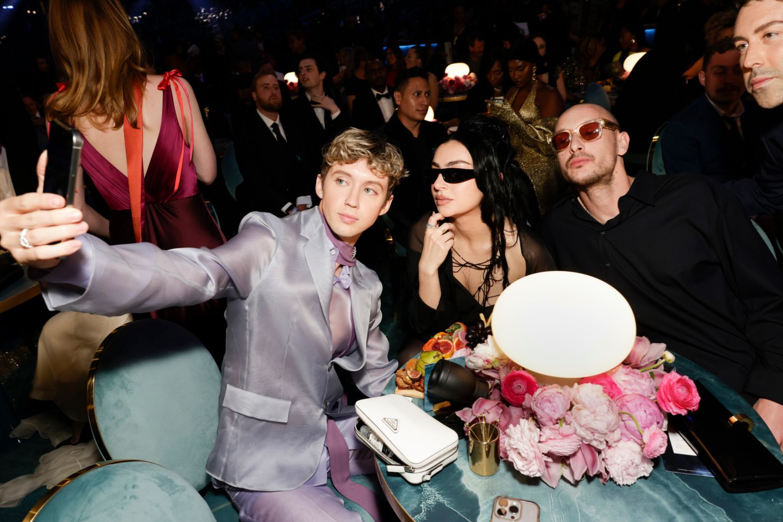 Troye Sivan takes a selfie with Charli XCX and George Daniel while attending the show.