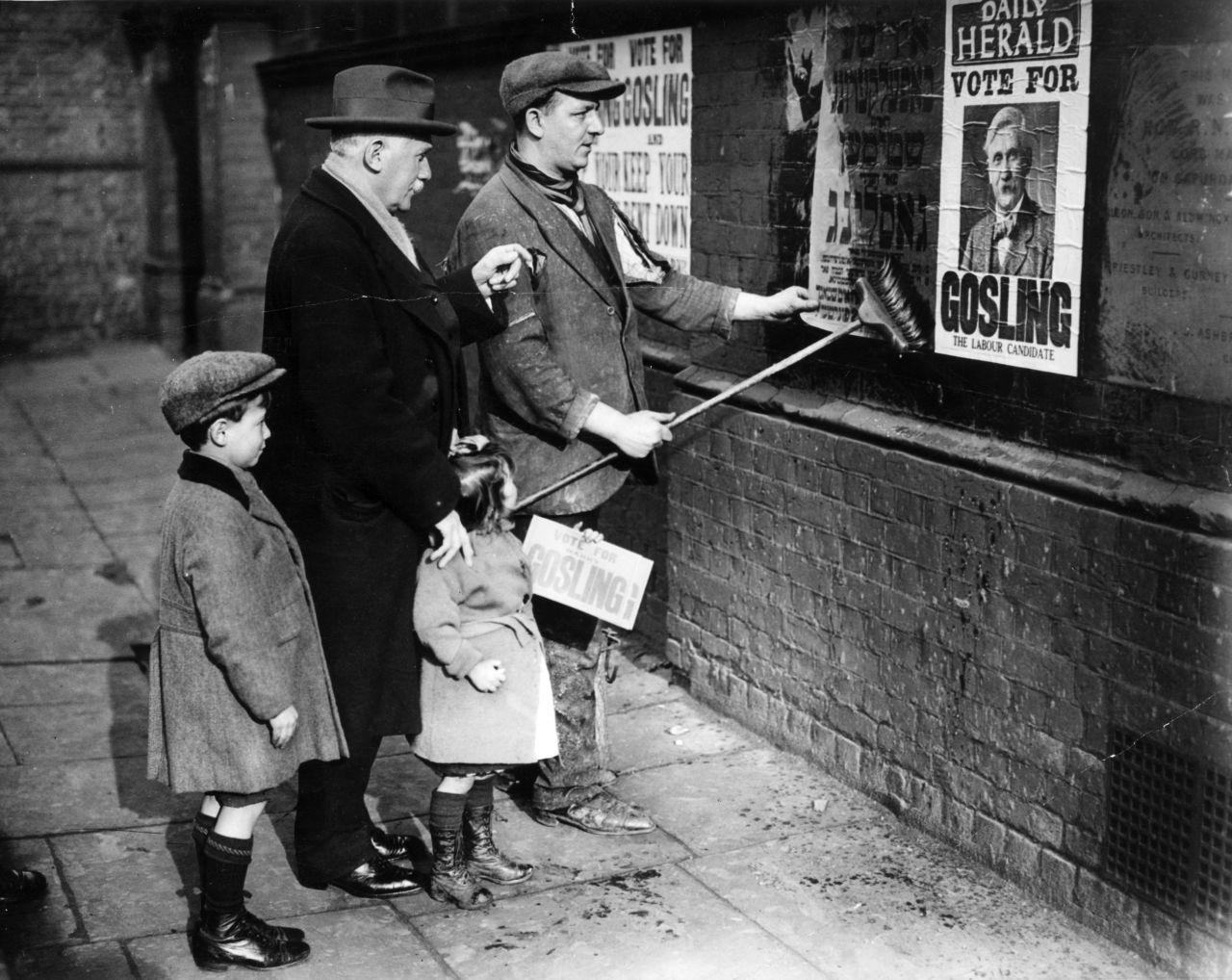 Labour Party candidate Henry Gosling supervises a poster campaign during the election.