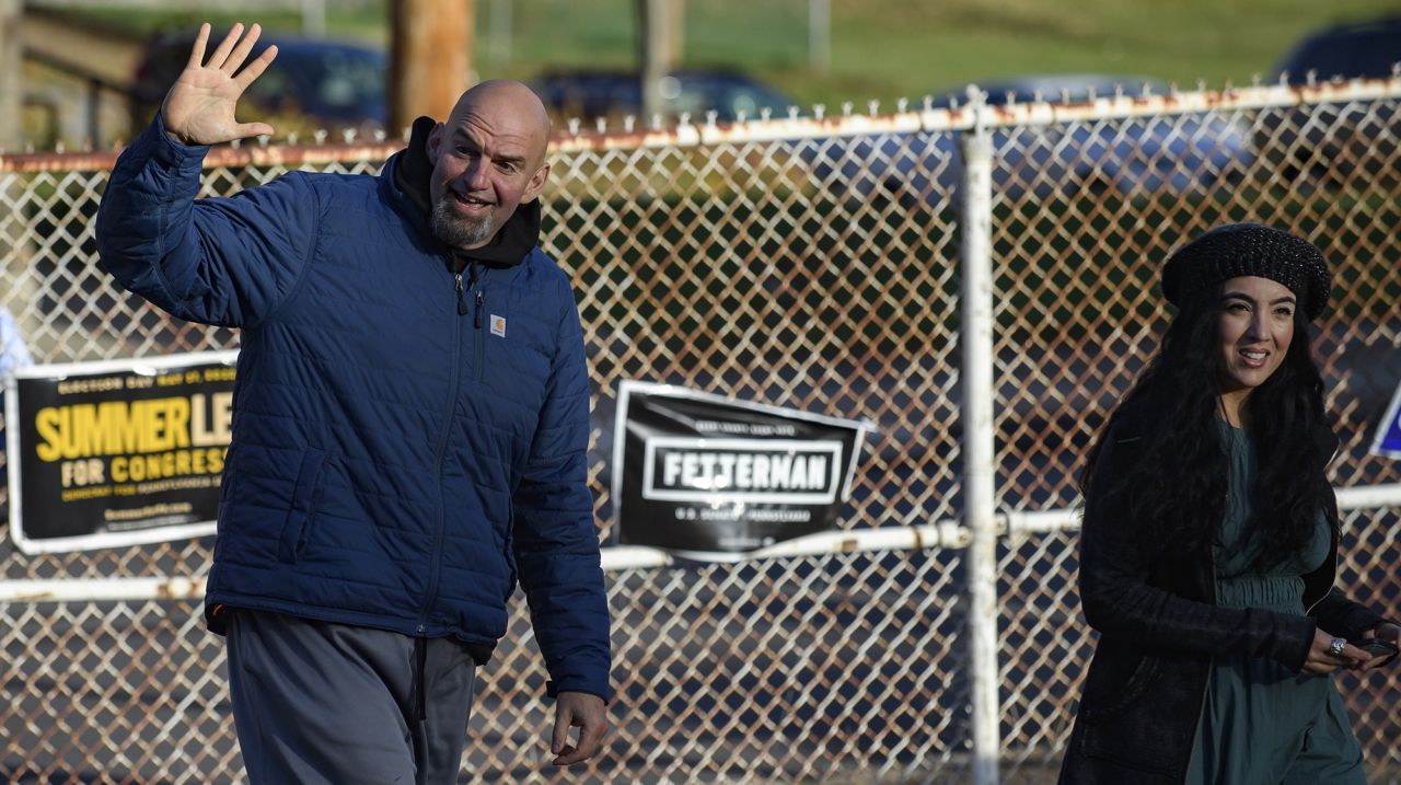 Pennsylvania Democratic Senate candidate John Fetterman and his wife, Gisele, walk into their polling place to cast their votes at the New Hope Baptist Church in Braddock, Pennsylvania on Tuesday. 