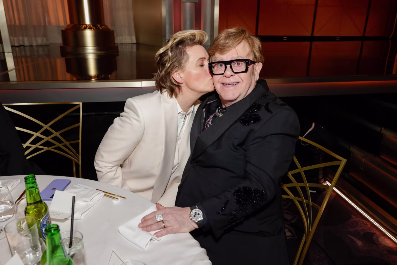 Brandi Carlile kisses Elton John.