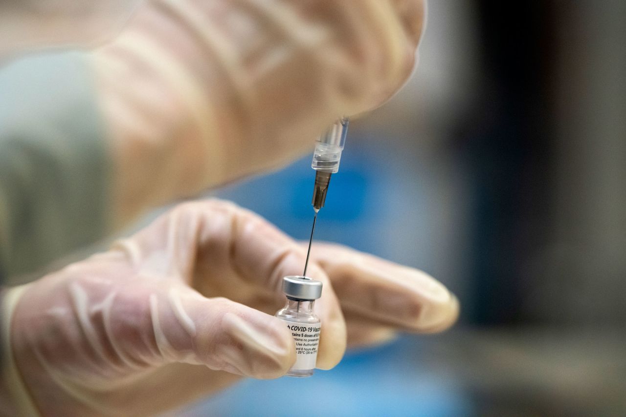 A health care worker in Portland, Oregon, prepares a Covid-19 vaccine dose in December 2020.