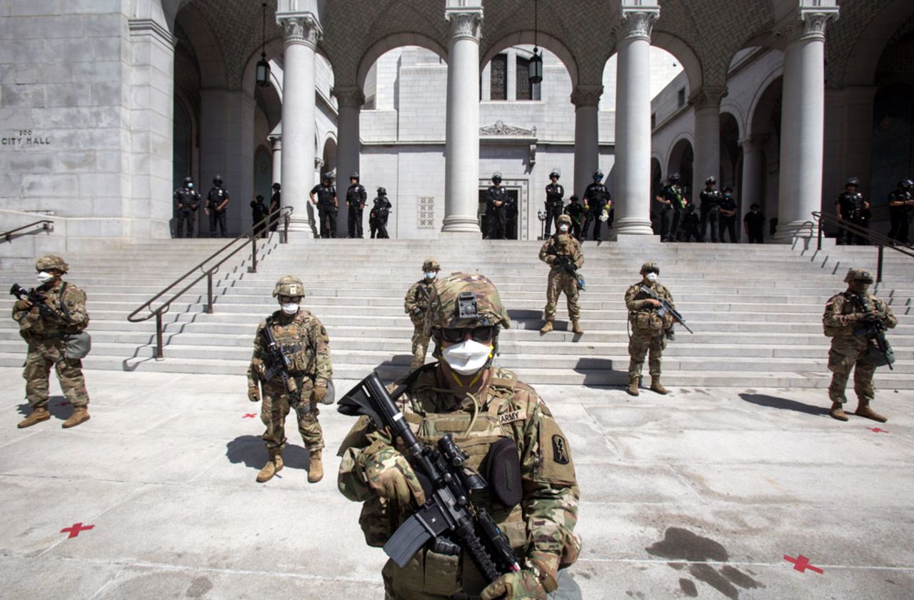 Members of California National Guard stand guard outside the City Hall on Sunday, May 31, in Los Angeles.