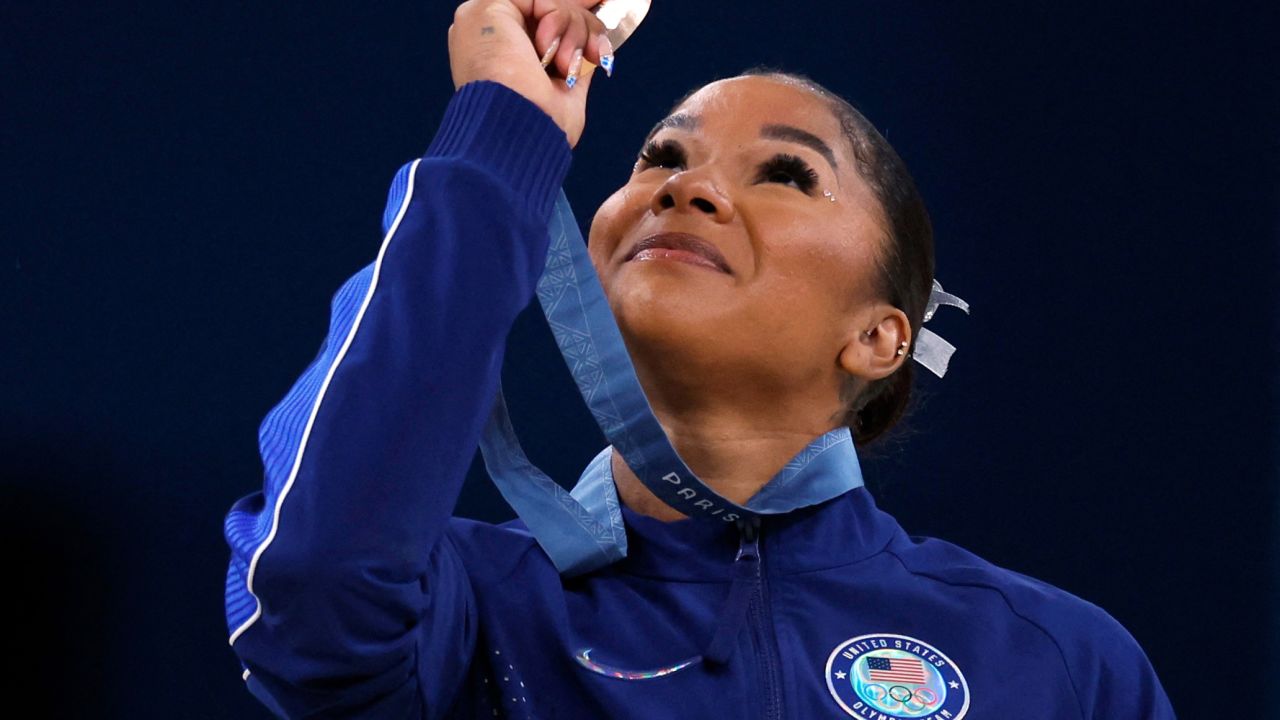 American gymnast Jordan Chiles looks at her bronze medal after the floor event on August 5.