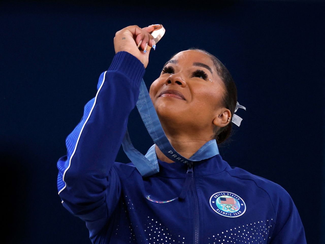 American gymnast Jordan Chiles looks at her bronze medal after the floor event on August 5. 