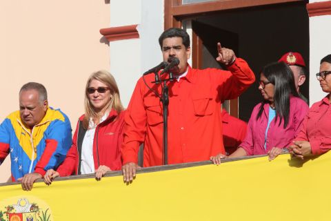 Nicolás Maduro (C) waves a national flag as he is escorted by Diosdado Cabello, president of National Constitutional Assembly; first lady Cilia Flores; executive Vice President Delcy Rodriguez and Major Erika Farias at the Balcón del Pueblo of the Miraflores Government Palace on Jan. 23, 2019 in Caracas, Venezuela. 