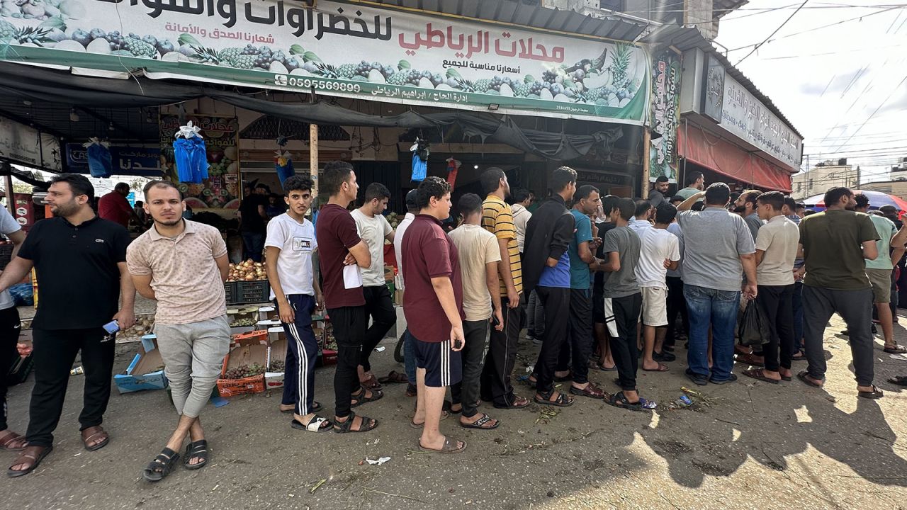 Palestinians wait in line to buy bread from a bakery in Deir al-Balah, Gaza, on Sunday.