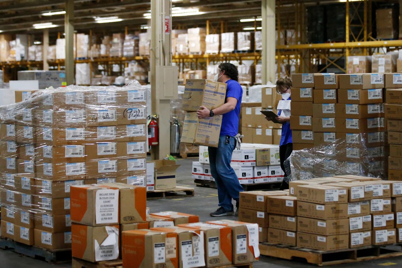 Workers carry boxes at Oklahoma's Strategic National Stockpile warehouse in Oklahoma City on April 7.