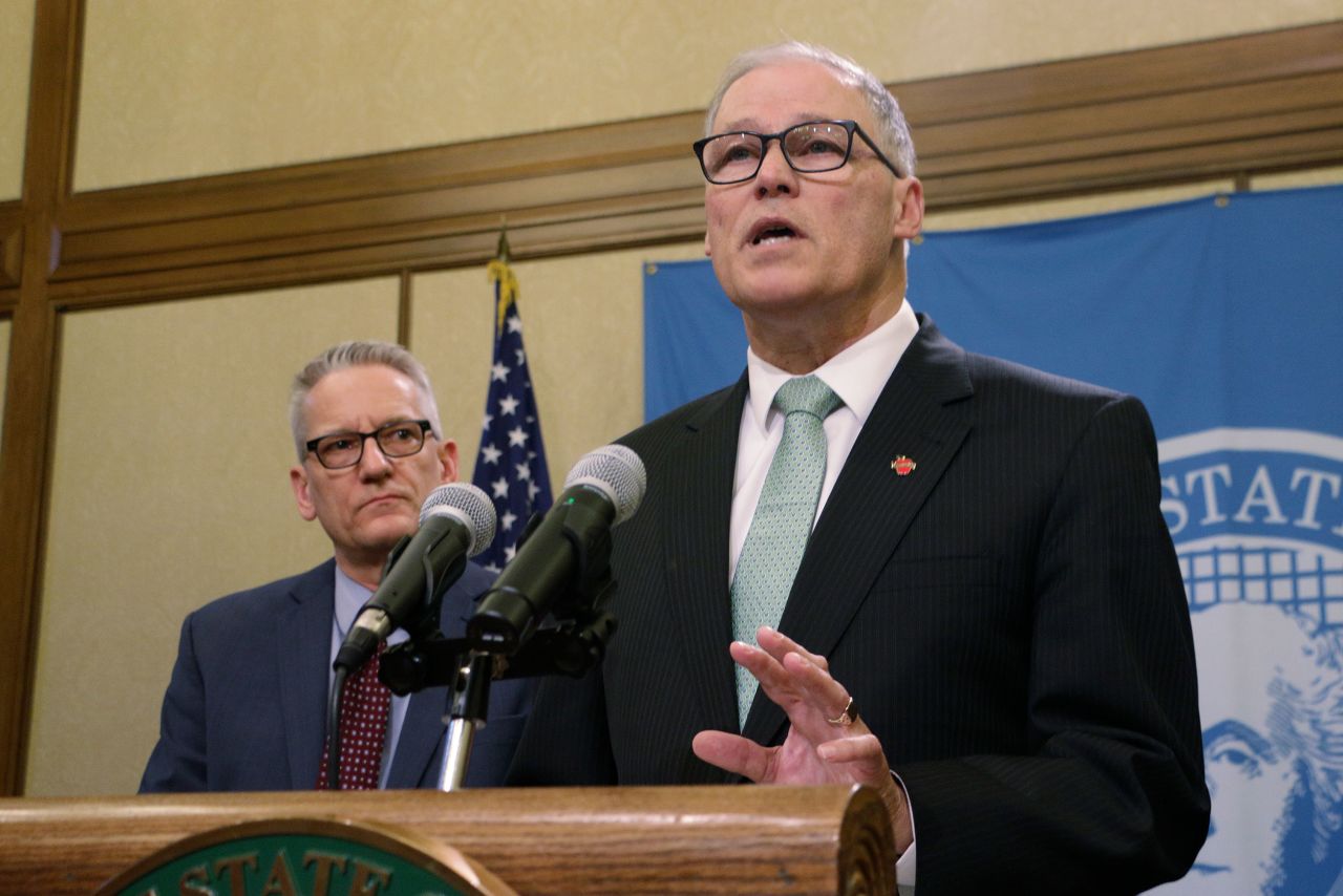 Inslee, right, talks to the media about Washington's coronavirus efforts on Monday, March 2.