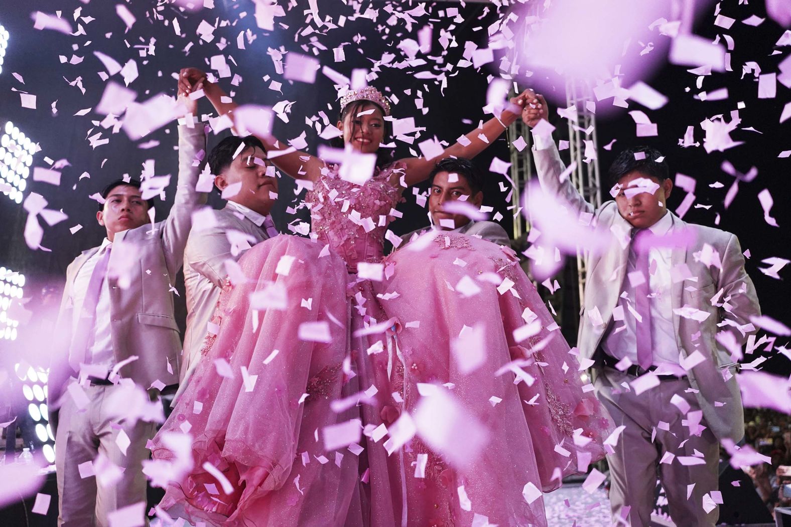 Confetti falls over Isela Santiago Morales during her 15th birthday party at a stadium in Axtla de Terrazas, Mexico, on Saturday, August 23. Her quinceañera was organized by the community after her first celebration was sparsely attended.